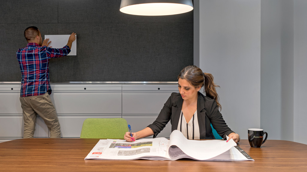 A person writing on a book.